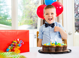 Image showing Birthday Boy With Cake And Present On Table