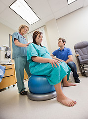 Image showing Nurse Assisting Pregnant Woman Sitting On Pilate Ball