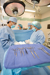 Image showing Multiethnic Doctors Operating Patient