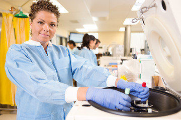 Image showing Pretty Lab Tech Loading Centrifuge