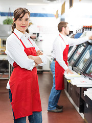 Image showing Female Butcher Standing Arms Crossed At Store