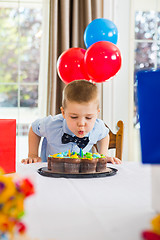 Image showing Boy Blowing Candles On Cake