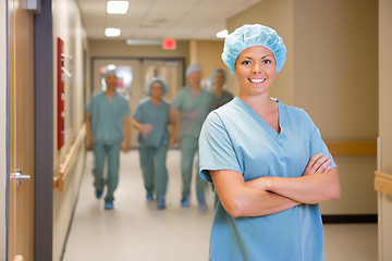 Image showing Surgeon Standing Arms Crossed In Hospital Corridor