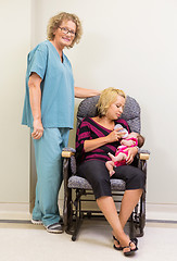 Image showing Nurse Standing By Mother Feeding Newborn Babygirl In Hospital