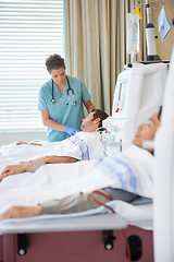 Image showing Nurse Looking At Patient Undergoing Renal Dialysis
