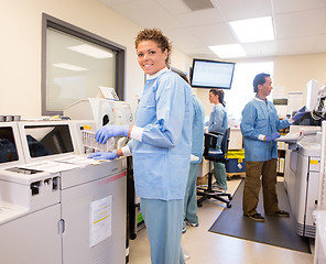 Image showing Lab Tech using backup Chemistry Analyzer