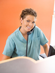 Image showing Nurse Answering Telephone While Working At Reception