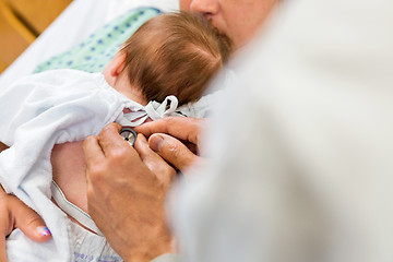 Image showing Doctor's Hands Examining Babygirl With Stethoscope