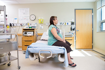 Image showing Thoughtful Pregnant Woman Sitting On Hospital Bed