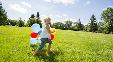 Image showing Girl With Colorful Balloons Running In Meadow