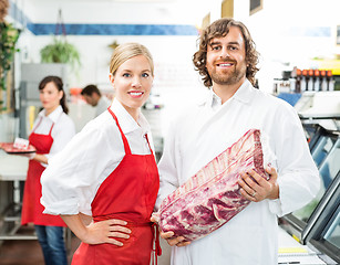 Image showing Confident Butchers With Meat Package