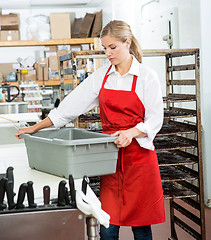 Image showing Worker Carrying Basket At Butcher's Shop