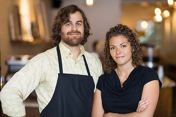 Image showing Confident Owners Standing Together In Cafe