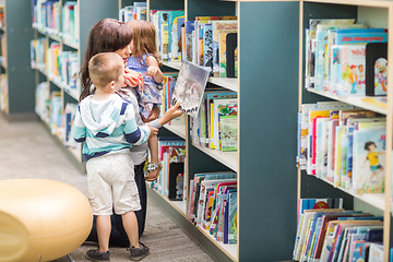 Image showing Teacher With Children Selecting Book In Library