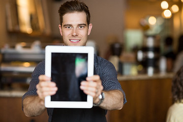 Image showing Cafe Owner Holding Digital Tablet In Restaurant