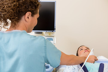 Image showing Nurse Scanning Female Patient's Neck