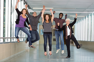 Image showing Excited Multiethnic University Students Jumping