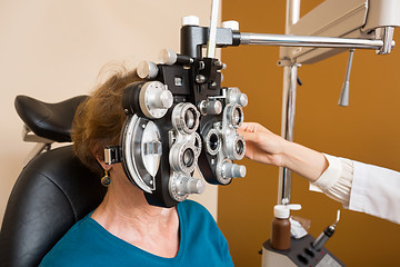 Image showing Woman Undergoing Eye Examination With Phoropter