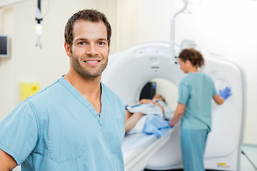 Image showing Nurse With Colleague Preparing Patient For CT Scan