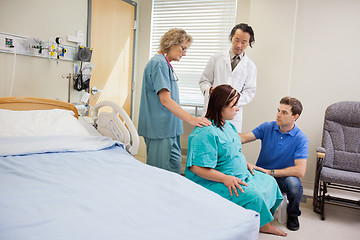 Image showing Medical Team And Man Looking At Pregnant Woman In Hospital