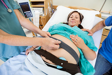 Image showing Nurse Attaching Fetal Monitor to Birthing Mother