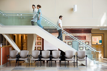 Image showing Medical Team And Man Using Staircase In Hospital