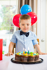 Image showing Boy Licking Lips While Looking At Birthday Cake