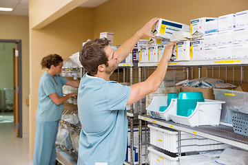 Image showing Nurses Arranging Stock In Storage Room