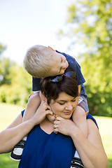 Image showing Mother Carrying Son On Shoulders In Park