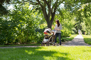 Image showing Mother Pushing Baby Carriage In Park