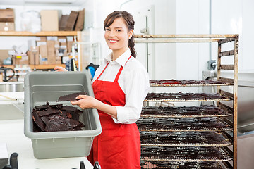 Image showing Worker Holding Beef Jerky And Basket At Butcher's Shop