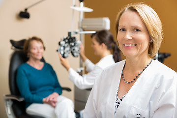 Image showing Confident Optometrist With Colleague Examining Patient