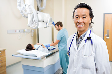 Image showing Doctor With Nurse Preparing Patient For Xray