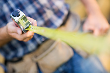 Image showing Carpenter Holding Tape Measure Outdoors