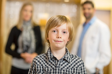 Image showing Confident Boy With Optometrist And Mother At Store