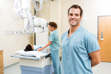 Image showing Nurse With Colleague Preparing Patient For Xray