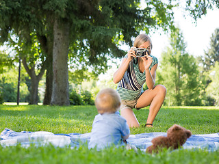 Image showing Mother Photographing Baby Boy At Park