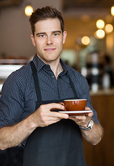Image showing Barista Standing in Cafe with Cup