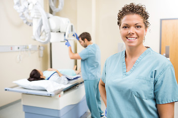 Image showing Nurse Smiling While Colleague Preparing Patient For Xray