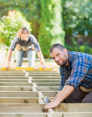 Image showing Carpenter Holding Drill At Building Site