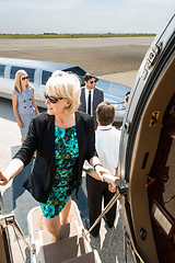 Image showing Mature Businesswoman Boarding Private Jet