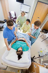 Image showing Doctors With Nurse Operating Pregnant Woman During Delivery