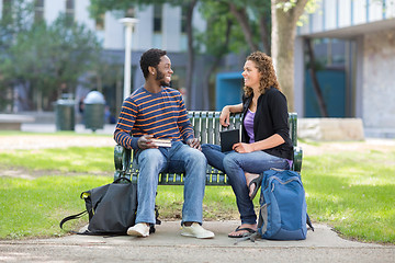 Image showing Students Sitting On Bench At University Campus