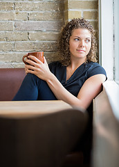 Image showing Woman Looking Through Window In Cafeteria