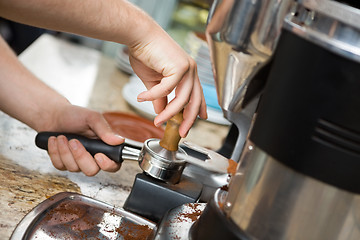 Image showing Barista Tamping Coffee