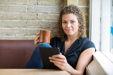 Image showing Woman With Coffee Mug And Digital Tablet In Cafe