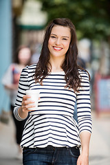 Image showing Woman Holding Disposable Coffee Cup