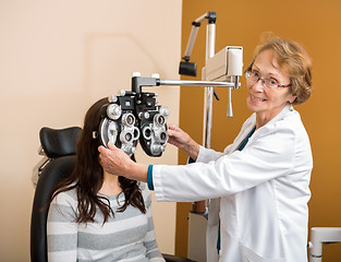 Image showing Optometrist Adjusting Phoropter For Young Patient