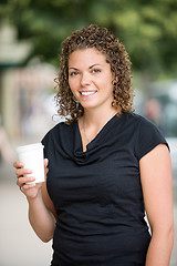 Image showing Woman Holding Disposable Coffee Cup Outdoors