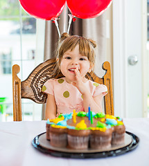 Image showing Happy Girl Sitting In Front Of Birthday Cake